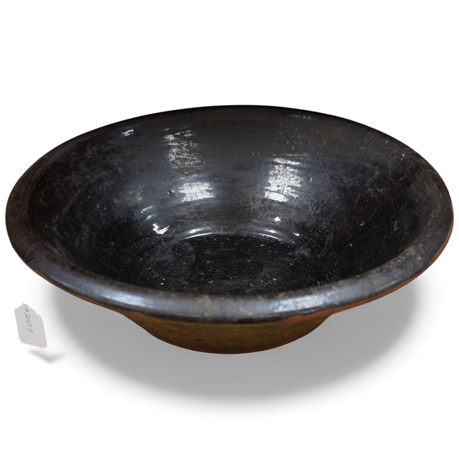 A large 19th century black glazed stoneware dairy bowl, 49cm diameter